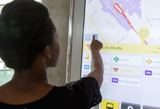 woman using the route map on a Connectpoint Interactive Kiosk