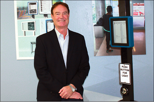 Rick Wood with the solar-powered Connectpoint Digital Bus Stop; Joshua Molina/Pacific Coast Business Times photo